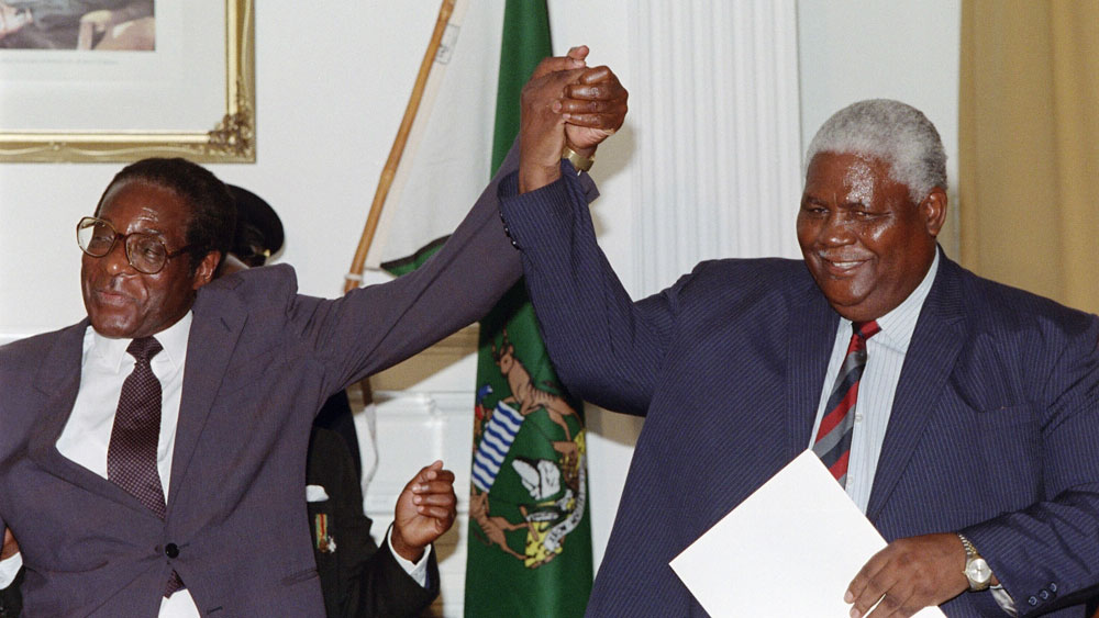 Robert Mugabe and Joshua Nkomo celebrating the signing of the Unity Accord in 1987